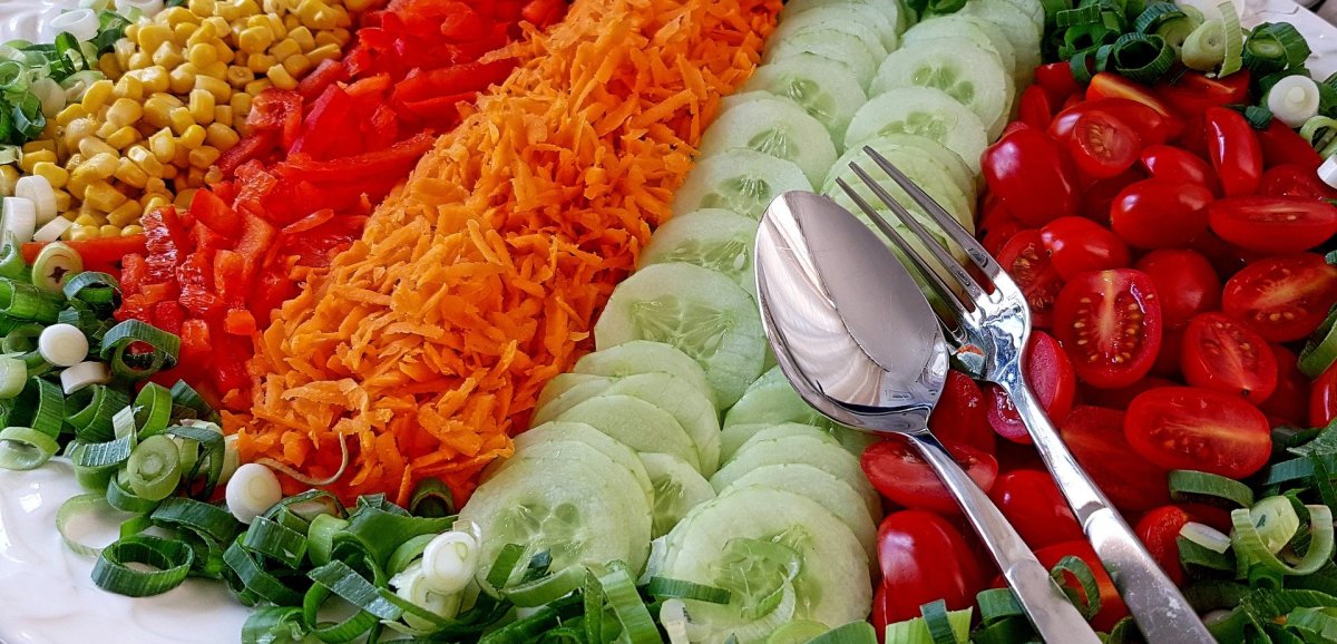 Colorful fresh fruits and vegetables are part of a healthy salad bar.