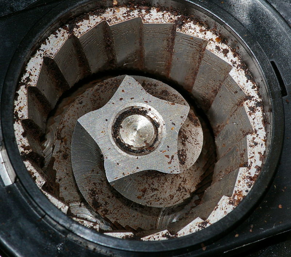 A burr grinder interior.  The bean hopper, which sits on top, has been removed in order to see inside.  The coffee beans are crushed and torn, rather than chopped, meaning that very little heat is generated. 