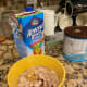 Put measured oats, Malt-O-Meal, peanut butter, sweetener, almond milk and Ovaltine in a tall-sided bowl 